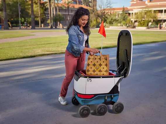 Person pick up food from grab hub rover