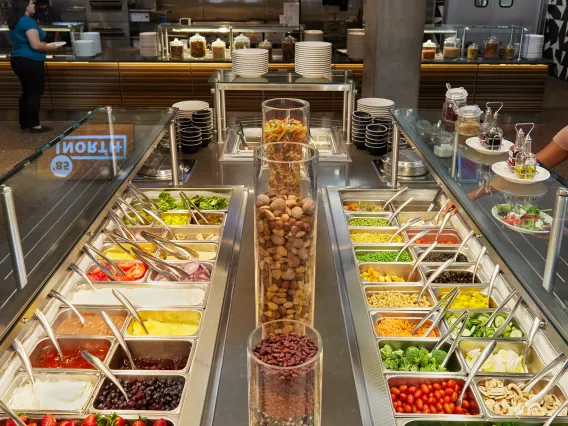 Student getting food from 85 North salad bar cropped image