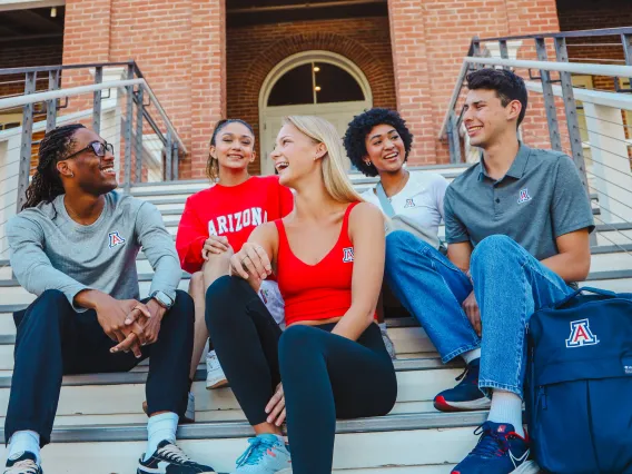 Group of student student Talking while sitting on the stair case at Old Main