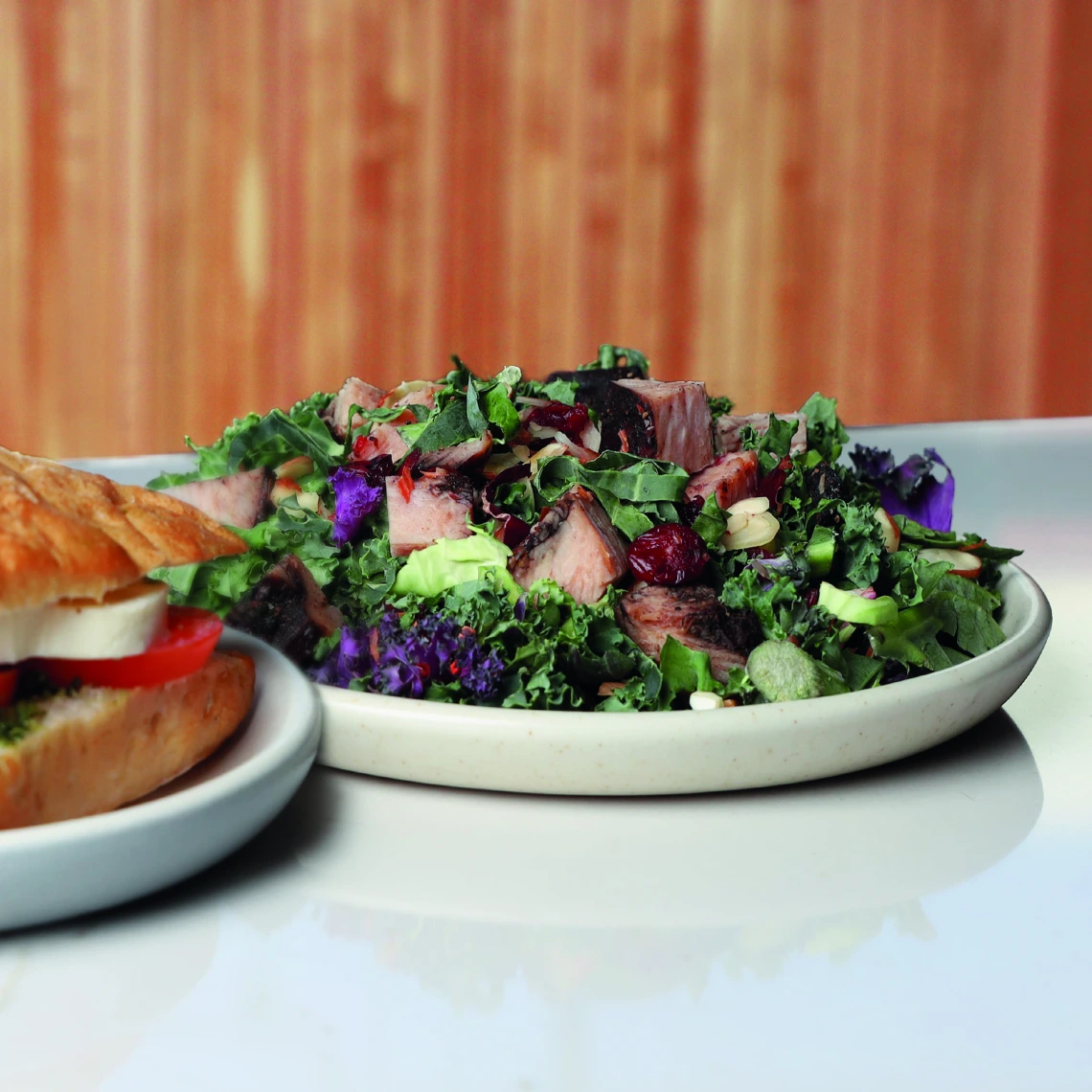 Catalyst, Salad with turkey and a sandwich in the foreground 